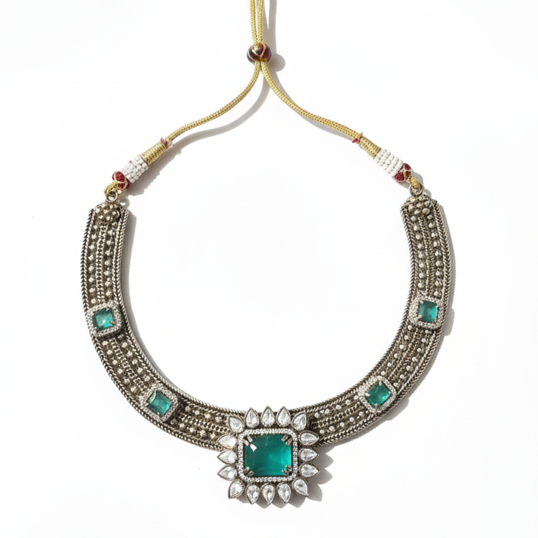 Ornate necklace with green gemstones on a white background